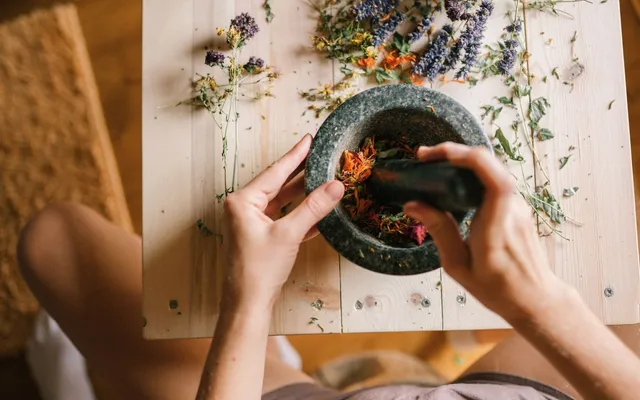 Grinding dried herbs with a mortar and pestle